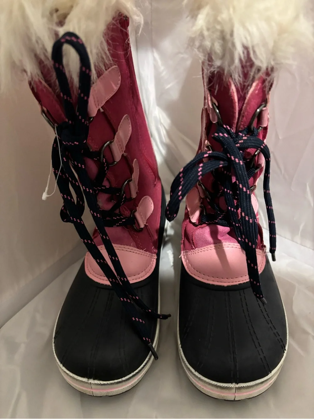 The image shows the black rubber lug outsole of an Ozark Trail kids' winter boot